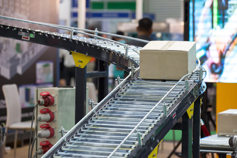 Box on conveyor belt in manufacturing plant for end of line packing 