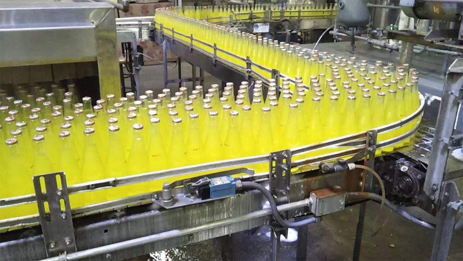 Bottles going through CSD Copackers end-of-line packaging process 