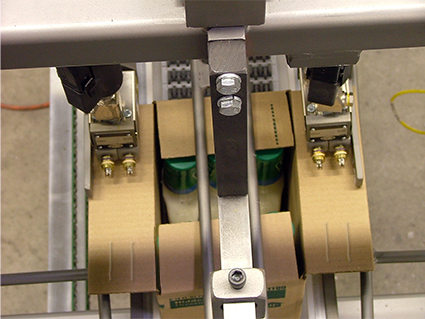 A Wayne RPS Case Sealer applying hot glue to case folds 