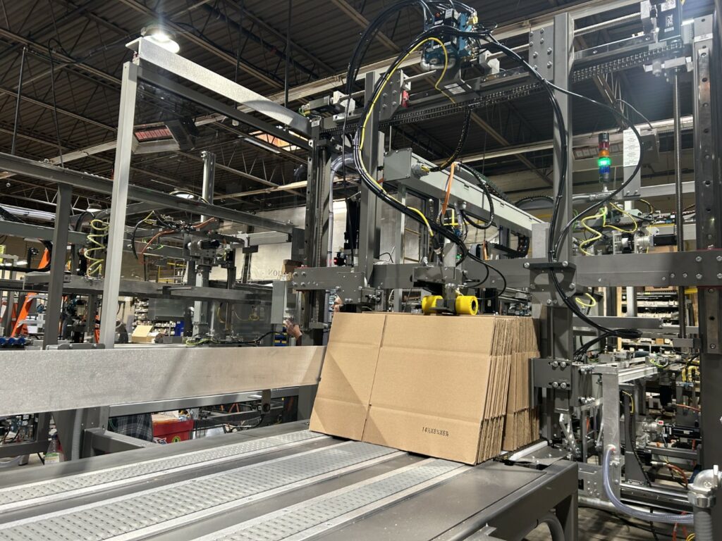 A stack of cardboard boxes on a Wayne Automation machine.