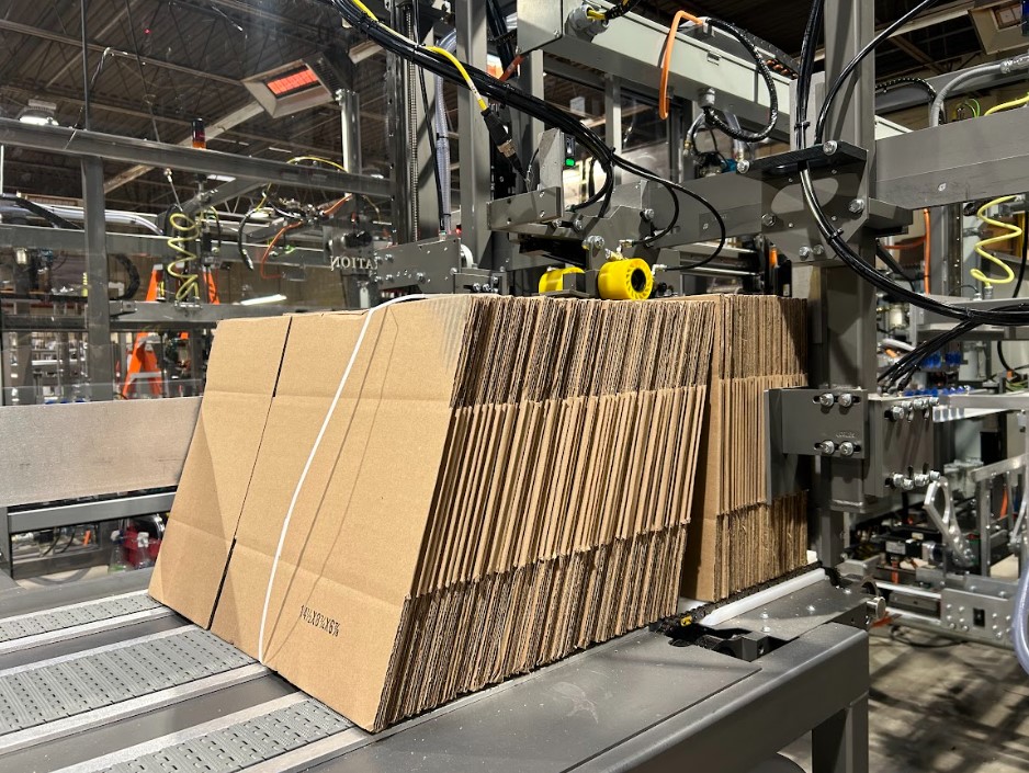 cardboard boxes stacked on a wayne automation machine