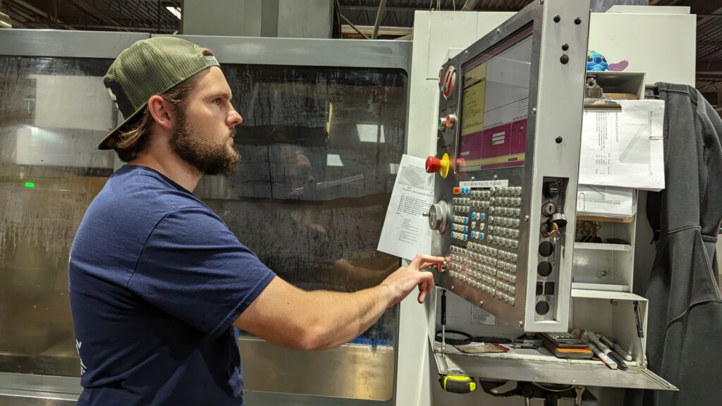 Photo of a Wayne Automation employee working on a machine.