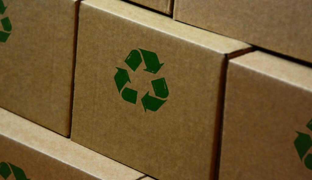 A cardboard box with the recycled logo on it. 