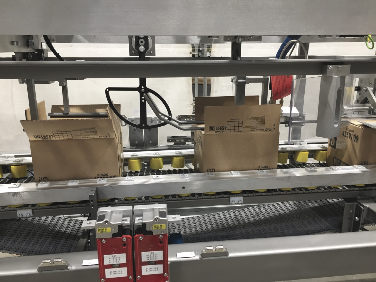 Wayne Automation’s RPS case sealer applying seals to beverage cartons on a high-speed packaging line.