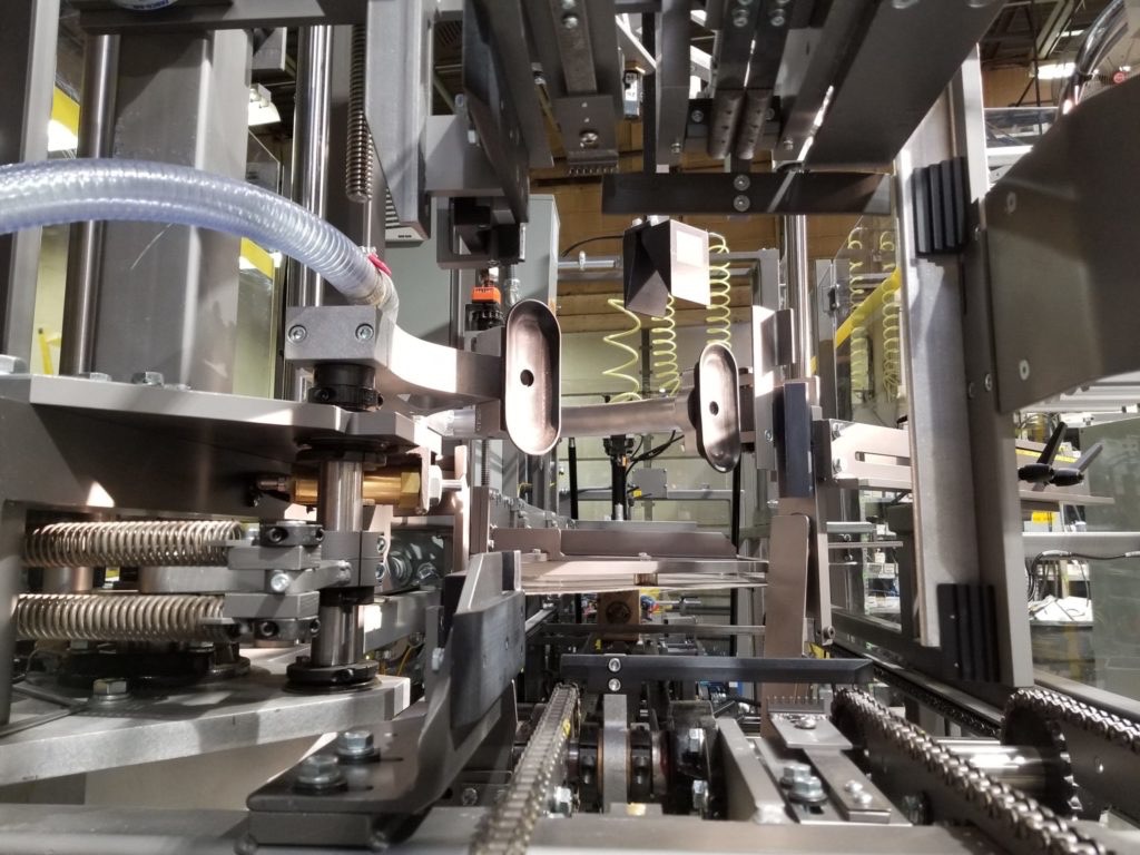 Interior image of the Wayne Automation VCE Case Erector. High speed auto case erector on manufacturing floor.